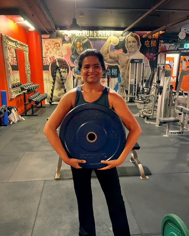 A LiFT member holding a weight plate