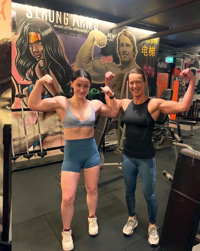 Two LiFT members flexing together
