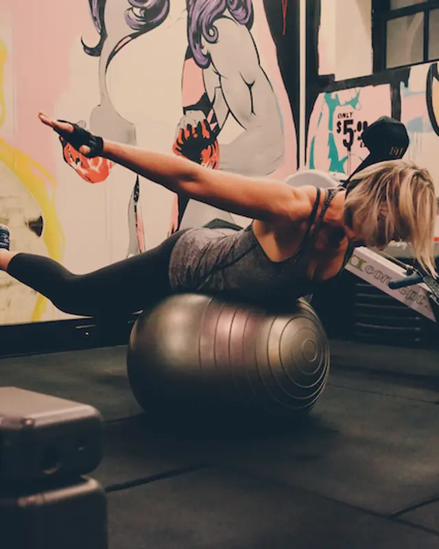 A member on a stability ball doing a core hold