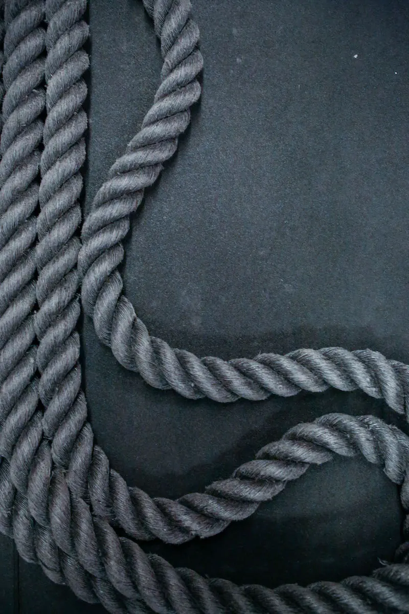Heavy training rope coiled on the rubber floor