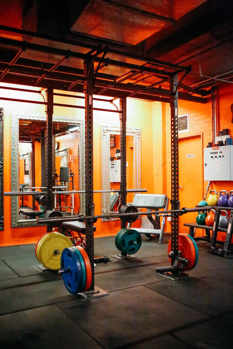Squat rack loaded with coloured bumper plates